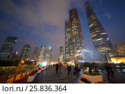 SHANGHAI, CHINA - NOV 6, 2015: Beautiful tall skyscrapers and people at night, China tallest skyscraper (Shanghai Tower) height of 630 meters. Редакционное фото, фотограф Losevsky Pavel / Фотобанк Лори