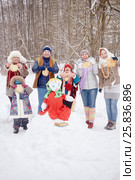 Six smiling people adults and children stand around stuffed Maslenitsa holding pancakes in hands at winter park. Стоковое фото, фотограф Losevsky Pavel / Фотобанк Лори