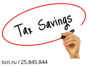 Man Hand writing Tax Savings with black marker on visual screen. Стоковое фото, фотограф Плотников Дмитрий / Фотобанк Лори