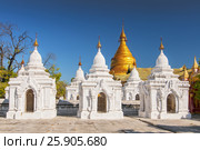 Kuthodaw Pagoda contains the worlds biggest book. There are 729 white stupas with caves with a marble slab inside - page with buddhist inscription. Mandalay, Myanmar. Стоковое фото, агентство BE&W Photo / Фотобанк Лори