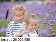 Girls walking outdoors in flowers field. Стоковое фото, фотограф Дмитрий Травников / Фотобанк Лори