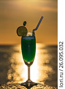 Glass of drink is on a beach table. Стоковое фото, фотограф М / Фотобанк Лори