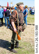 Unidentified member of Historical reenactment in German Army uniform during historical reenactment of battlefield in 1943 in summer day (2017 год). Редакционное фото, фотограф FotograFF / Фотобанк Лори