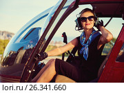 Attractive woman pilot sitting in the helicopter. Стоковое фото, фотограф Alexander Tihonovs / Фотобанк Лори