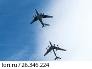 RUSSIA, SARATOV - MAY 6, 2017: Air tanker Ilyushin IL-78 and Strategic bomber Tu-95 "Bear" simulate in-flight refueling at Parade of Victory in World War II. Russian planes. Редакционное фото, фотограф Sergey Borisov / Фотобанк Лори