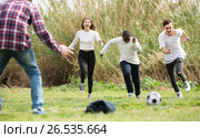 girl and three boys playing football in spring park and smiling. Стоковое фото, фотограф Яков Филимонов / Фотобанк Лори