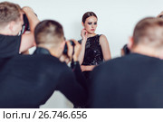 Photographers paparazzi take photos of woman in cocktail dresses. Стоковое фото, фотограф Женя Канашкин / Фотобанк Лори