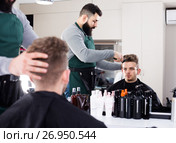 client feeling discontent about his new haircut at hair salon. Стоковое фото, фотограф Яков Филимонов / Фотобанк Лори