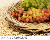 Juicy fresh red and white grapes in a wattled basket. Стоковое фото, фотограф ElenArt / Фотобанк Лори