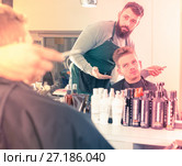 Client looking displeased about new haircut. Стоковое фото, фотограф Яков Филимонов / Фотобанк Лори