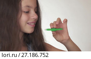 Beautiful cheerful teen girl playing with green fidget spinner on white background stock footage video. Стоковое видео, видеограф Юлия Машкова / Фотобанк Лори