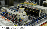 Electrical modules, switches, relays and cables are mounted on the circuit board. Стоковое видео, видеограф Андрей Радченко / Фотобанк Лори