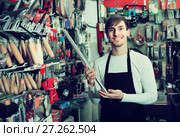 male seller posing at tooling section of household store. Стоковое фото, фотограф Яков Филимонов / Фотобанк Лори