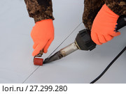 Waterproofing and insulation at construction site, roof sealing process of synthetic membrane with Hot Air Hand Tool. New protection technology. Closeup. Стоковое фото, фотограф Сергей Дорошенко / Фотобанк Лори