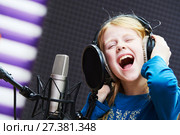 Regording studio. Child girl singing or role voicing. Стоковое фото, фотограф Дмитрий Калиновский / Фотобанк Лори
