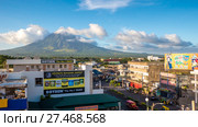 LEGAZPI, PHILIPPINES - JANUARY 5, 2018: - Mount Mayon volcano looms over the city as daily life goes on. Редакционное фото, фотограф Mikhail Davidovich / Фотобанк Лори