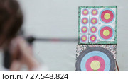 Close up beautiful woman aims a crossbow at a target. Стоковое видео, видеограф Roman Larchikov / Фотобанк Лори