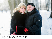 Счастливая семья. Мужчина и женщина средних лет стоят в обнимку на прогулке в зимним парке. Стоковое фото, фотограф Игорь Низов / Фотобанк Лори