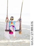 happy girl is rocking at the beach. Стоковое фото, фотограф Hannes Eichinger / PantherMedia / Фотобанк Лори