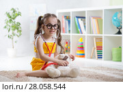 Adorable child playing doctor in daycare. Стоковое фото, фотограф Оксана Кузьмина / Фотобанк Лори
