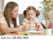 Kindergarten teacher and child girl drawing lessons at school. Стоковое фото, фотограф Оксана Кузьмина / Фотобанк Лори