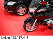 Black shiny bike for cortege, car are on red carpet in exhibition hall. Стоковое фото, фотограф Losevsky Pavel / Фотобанк Лори