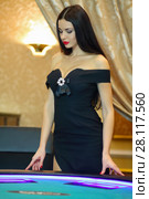 Young beautiful women poses near poker electronic table in luxury casino. Стоковое фото, фотограф Losevsky Pavel / Фотобанк Лори