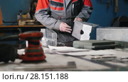 Worker assembling the metal part by hand with pliers, tools for grinding metal and metal details in the foreground. Стоковое видео, видеограф Константин Шишкин / Фотобанк Лори