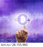 Icons bitcoin ripple, ethereum on an ultra purple background of the city. The hand touches the bitcoin icon. Стоковое фото, фотограф Ярослав Данильченко / Фотобанк Лори