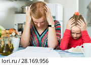 woman working from home, little daughter asking for attention. Стоковое фото, фотограф Яков Филимонов / Фотобанк Лори