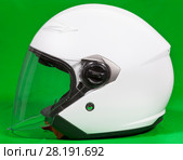 Open face white motorcycle helmet with attached face shield, side view, green background. Стоковое фото, фотограф Кекяляйнен Андрей / Фотобанк Лори