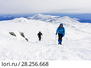 Two mountaineers goes up the snow-covered mountain slope. Стоковое фото, фотограф Евгений Харитонов / Фотобанк Лори