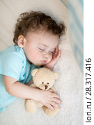 Sleeping baby in bed, holding a teddy bear. Стоковое фото, фотограф Оксана Кузьмина / Фотобанк Лори