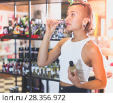 modern woman choosing bottle of pheromones. Стоковое фото, фотограф Яков Филимонов / Фотобанк Лори