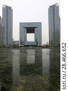 TIANJIN, CHINA - APRIL 8, 2017. A modern building along the Haihe River in Tianjin, China. Редакционное фото, фотограф Яна Королёва / Фотобанк Лори