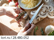 Woman cooking pizza at home. Unrecognizable woman cutting shrimp. Стоковое фото, фотограф Kirill Kedrinskiy / Ingram Publishing / Фотобанк Лори