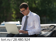 Man with laptop at summer park on bright day. Стоковое фото, фотограф Kirill Kedrinskiy / Ingram Publishing / Фотобанк Лори