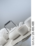 Teapot and cups on table at comfortable relaxation lounge. Стоковое фото, фотограф Kirill Kedrinskiy / Ingram Publishing / Фотобанк Лори