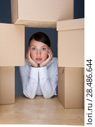 Tired young woman surrounded by carboard boxes. Стоковое фото, фотограф Kirill Kedrinskiy / Ingram Publishing / Фотобанк Лори