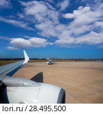 Airplane wing in airport with aircraft background with blue sky. Стоковое фото, фотограф Tono Balaguer / Ingram Publishing / Фотобанк Лори