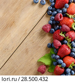Strawberries raspberries and blueberries on the wooden table macro. Стоковое фото, фотограф Olena Mykhaylova / Ingram Publishing / Фотобанк Лори