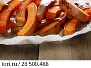 Homemade halloween baked pumpkin slices on baking paper. Стоковое фото, фотограф Olena Mykhaylova / Ingram Publishing / Фотобанк Лори