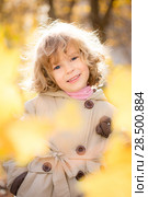 Portrait of happy child in autumn. Frame of golden maple leaves. Стоковое фото, фотограф Igor Yaruta / Ingram Publishing / Фотобанк Лори