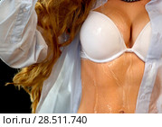 Sexual woman drinking water from bottle, pours on breasts. Стоковое фото, фотограф Gennadiy Poznyakov / Фотобанк Лори
