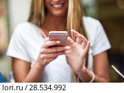 Close-up image of young blonde girl texting with smartphone, female hands typing text message via cellphone, social networking concept. Стоковое фото, фотограф Javier Sánchez Mingorance / Ingram Publishing / Фотобанк Лори