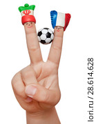 Two fingers in the clay caps with a soccer ball isolated on white background. Fans of Iran and France. Стоковое фото, фотограф Элина Гаревская / Фотобанк Лори