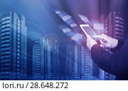 Male hands with smartphone on icons flying and skyscrapers background. Стоковое фото, фотограф Яков Филимонов / Фотобанк Лори