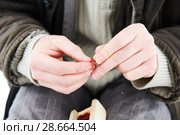 Fisherman adding mosquito grub on hook at winter fishing. Стоковое фото, фотограф Дмитрий Калиновский / Фотобанк Лори