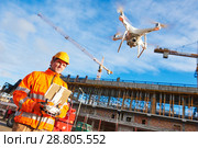 Drone operated by construction worker on building site. Стоковое фото, фотограф Дмитрий Калиновский / Фотобанк Лори