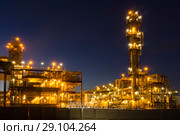 Night industrial landscape with bright lights of lanterns - fluid catalytic cracking unit (FCC) in a modern chemical factory. equipment of oil refinery. Стоковое фото, фотограф Евгений Харитонов / Фотобанк Лори